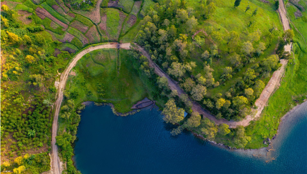 Aerial view of a winding road above the shore of Lake Kivu