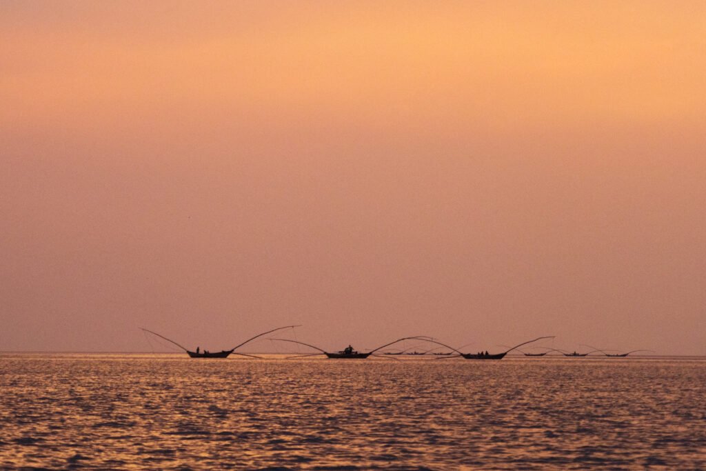 Traditional fishing boats on Lake Kivu at sunset